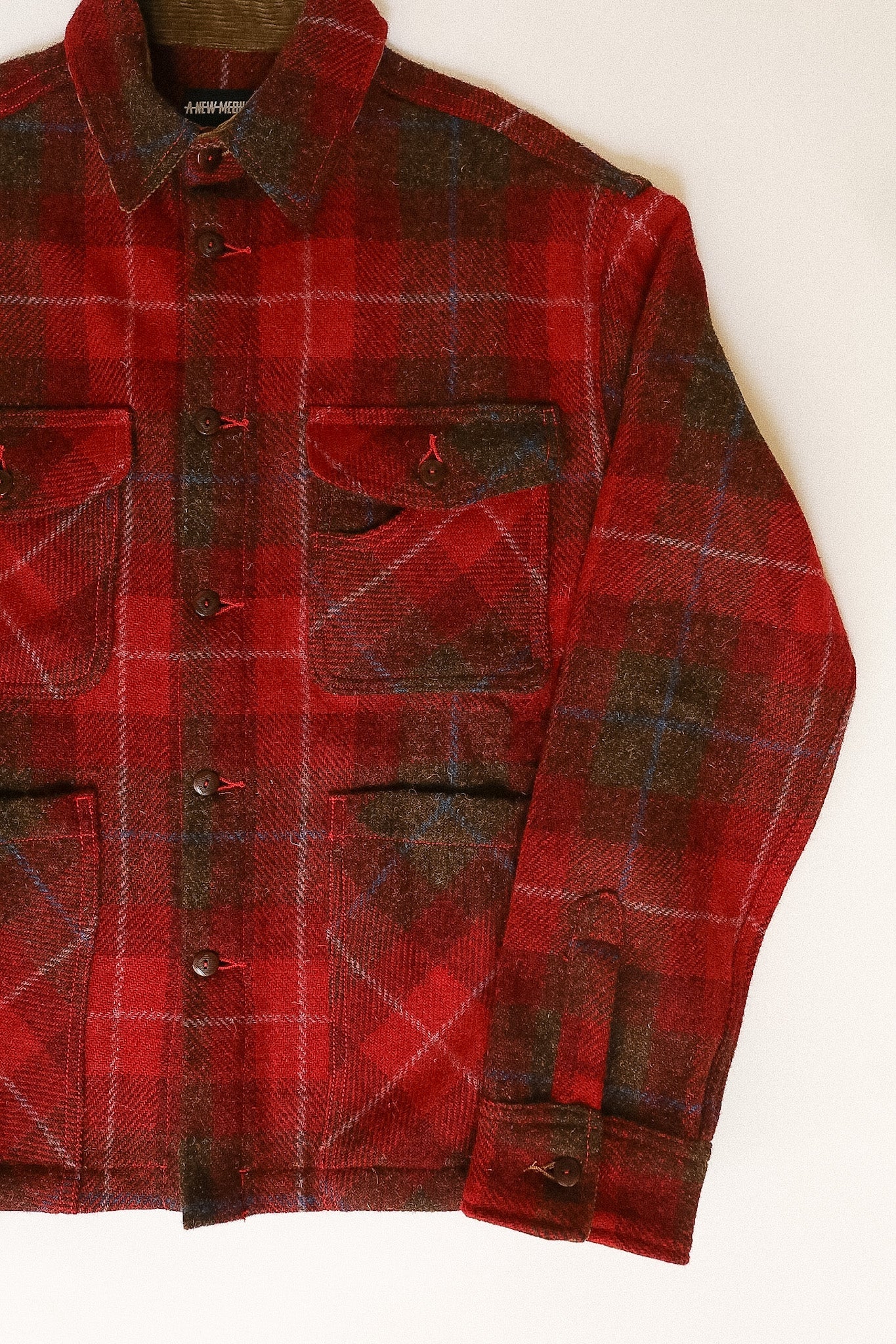 Red and brown plaid shirt on a white background
